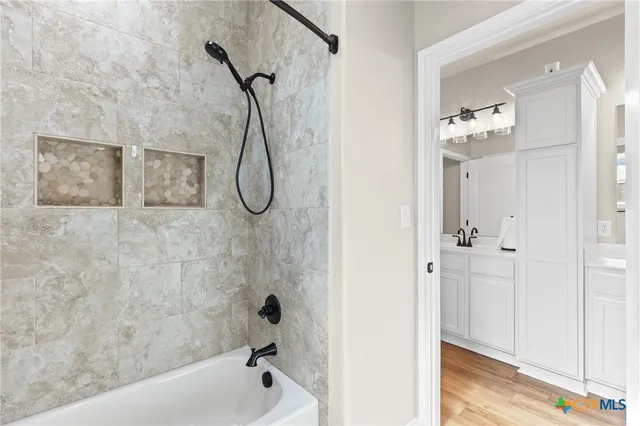 a spacious bedroom with a bed and a flat screen tv