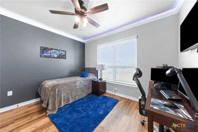 a bedroom with a bed and a chandelier