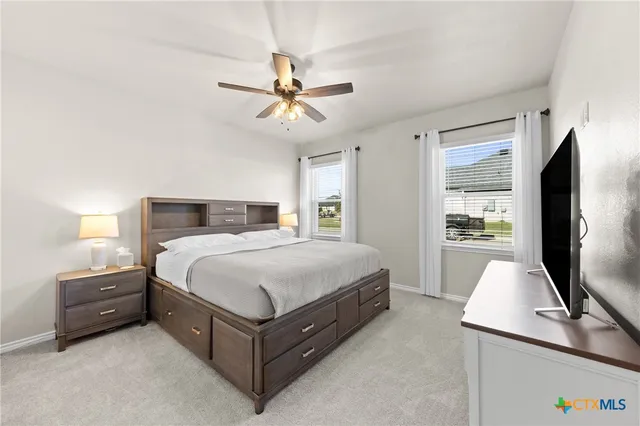 a kitchen with a refrigerator and a stove top oven