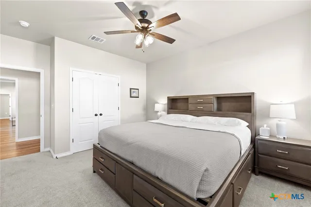 a bedroom with a bed and a chandelier