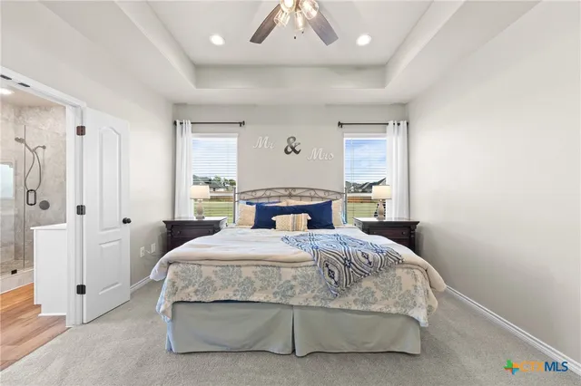 a white bath tub sitting next to a toilet