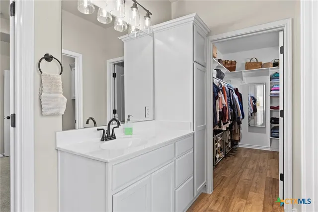 a living room with patio furniture and a flat screen tv