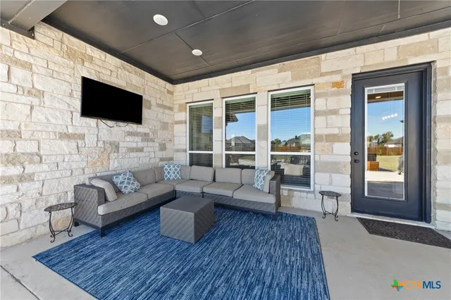 a view of a lake with couches in front of house