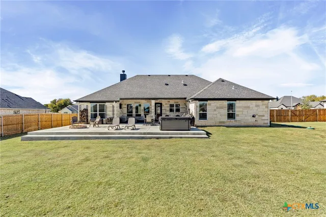 a front view of house with yard and car parked