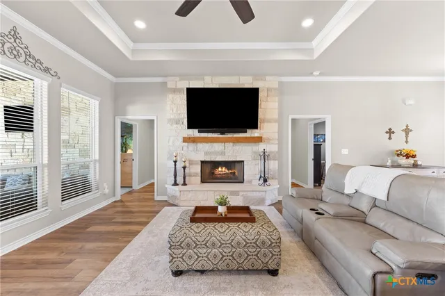 a living room with furniture a fireplace and a flat screen tv