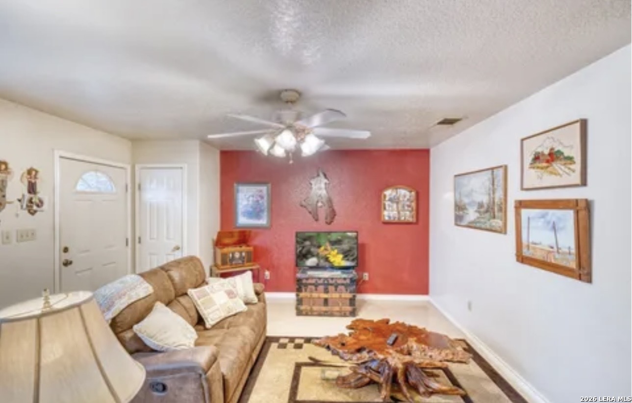 622 South Oak Street Pearsall, TX 78061 - Photo 4 of 22 a living room with furniture and a chandelier