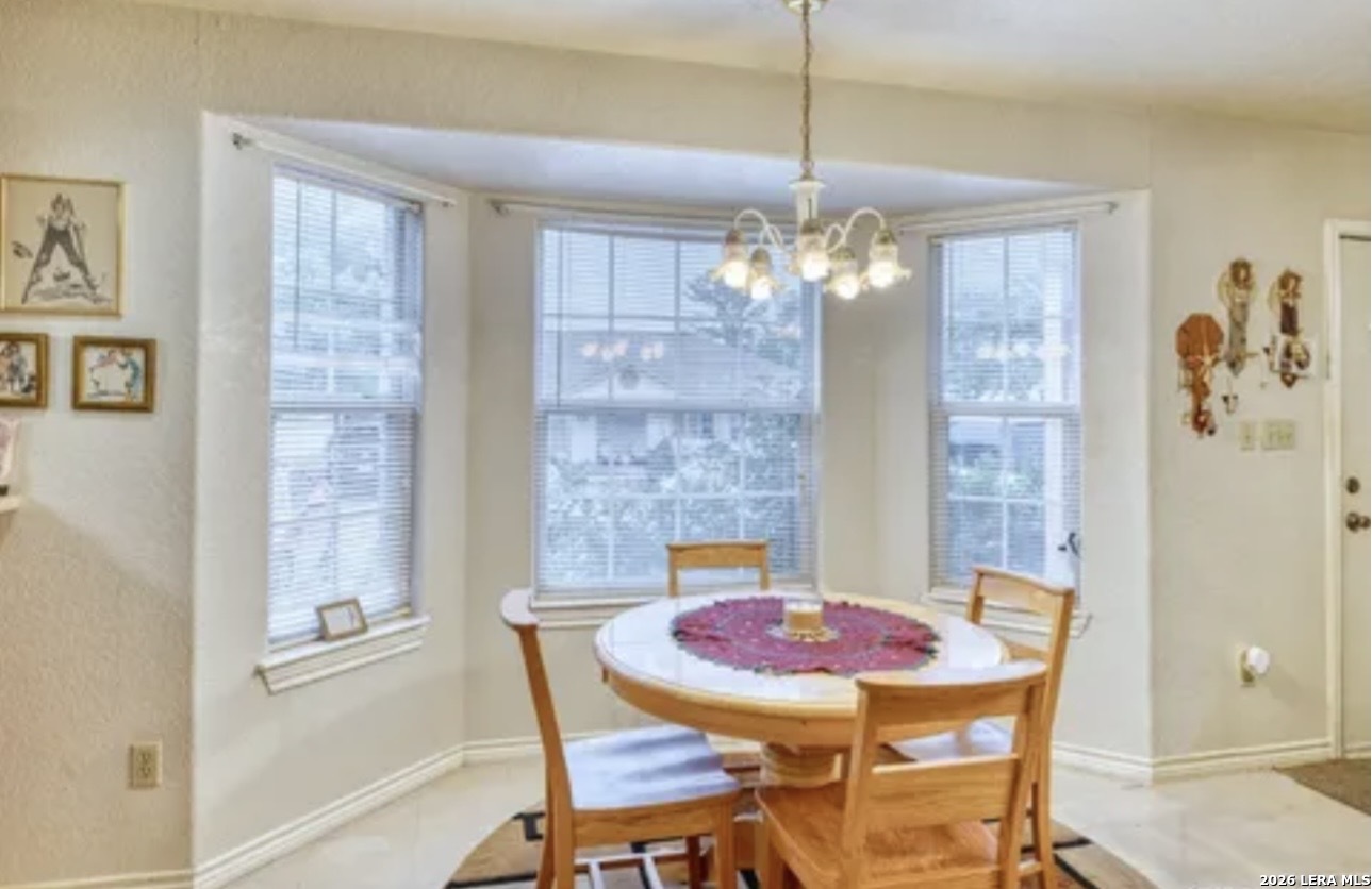 622 South Oak Street Pearsall, TX 78061 - Photo 5 of 22 a view of a dining room with furniture and chandelier