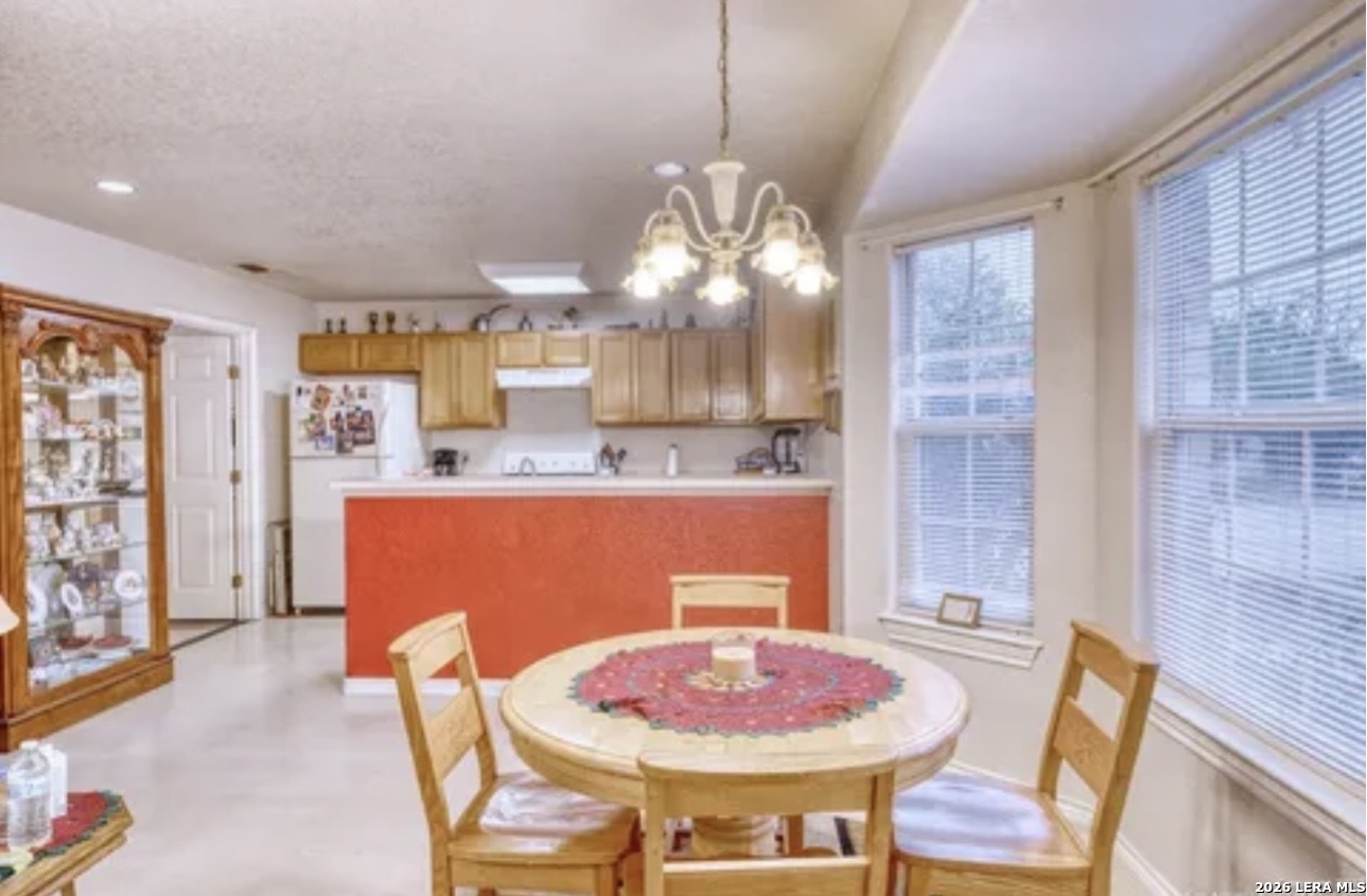 622 South Oak Street Pearsall, TX 78061 - Photo 6 of 22 a dining room with a table or chairs and a wooden floor