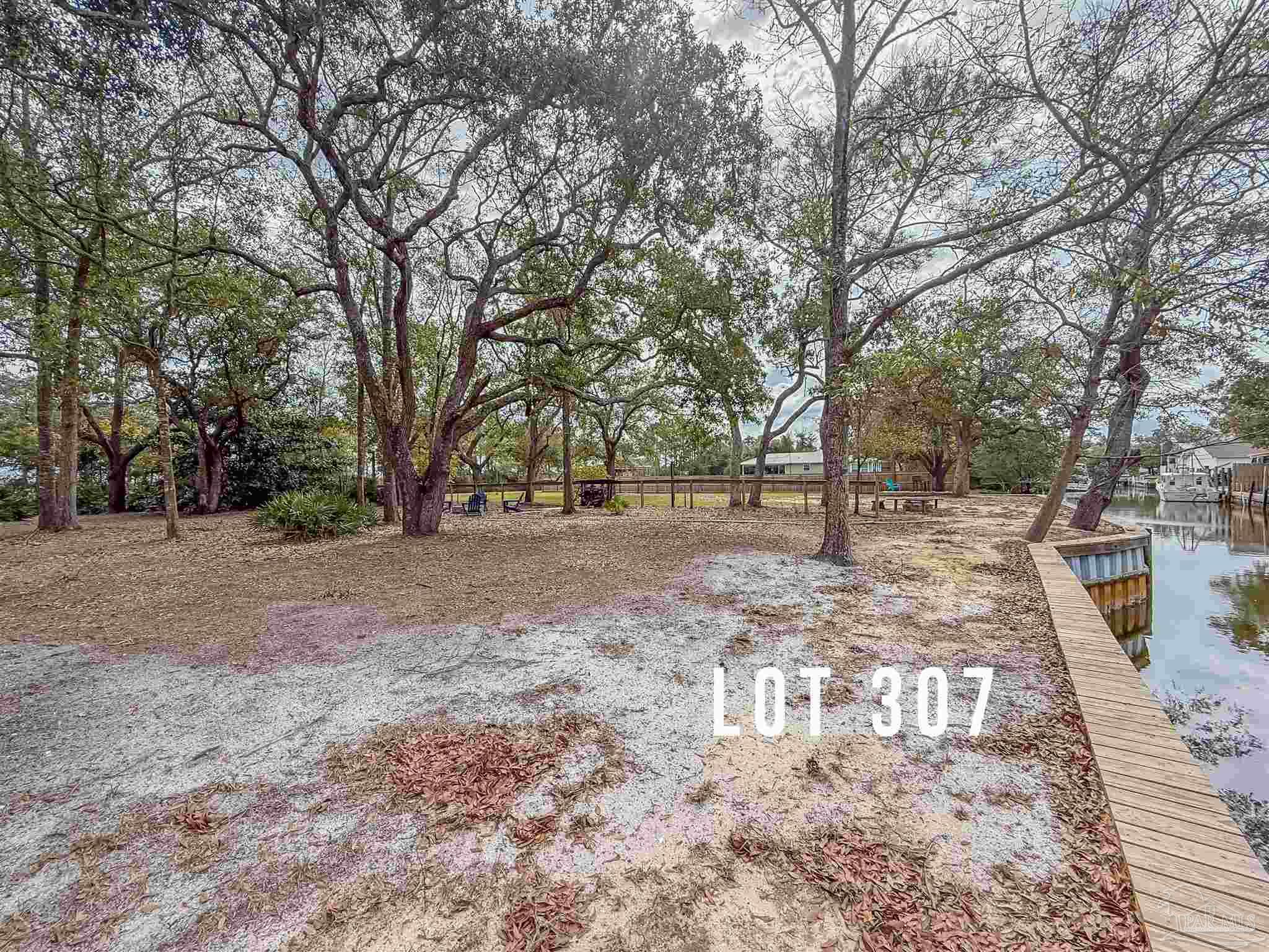 307 Katie Street Milton, FL 32583 - Photo 14 of 17 a view of outdoor space with deck and trees
