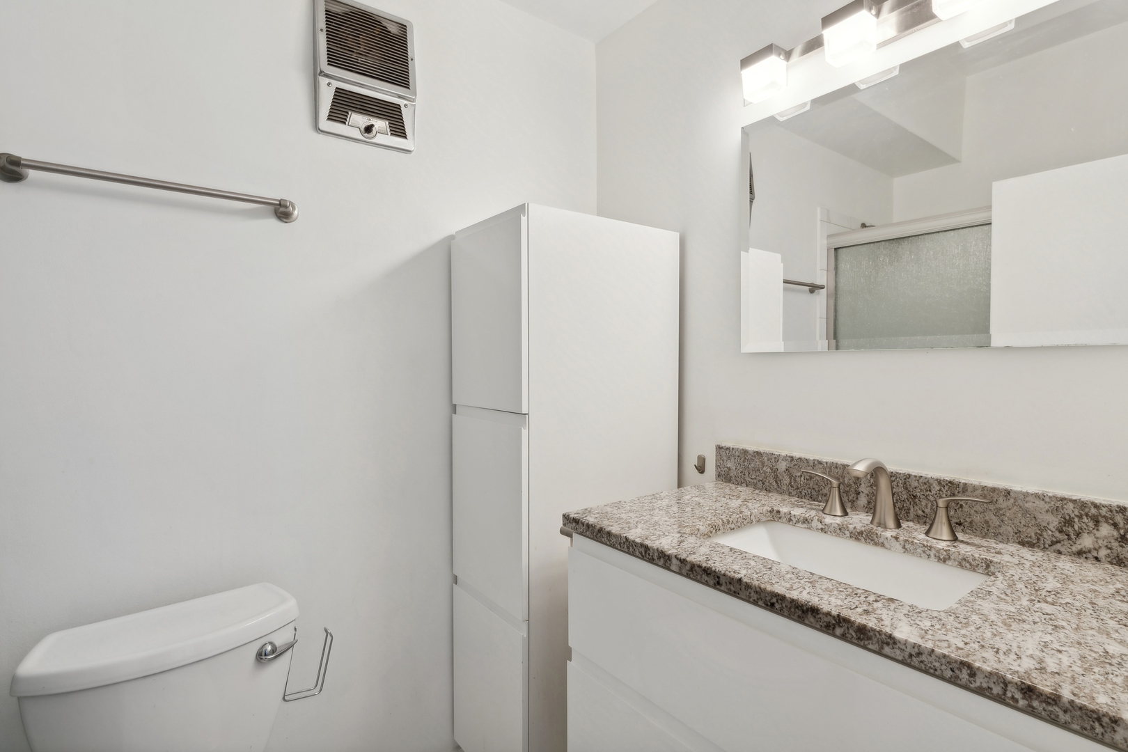 9009 Golf Road, Unit 10F Des Plaines, IL 60016 - Photo 15 of 17 a bathroom with a granite countertop sink toilet and mirror