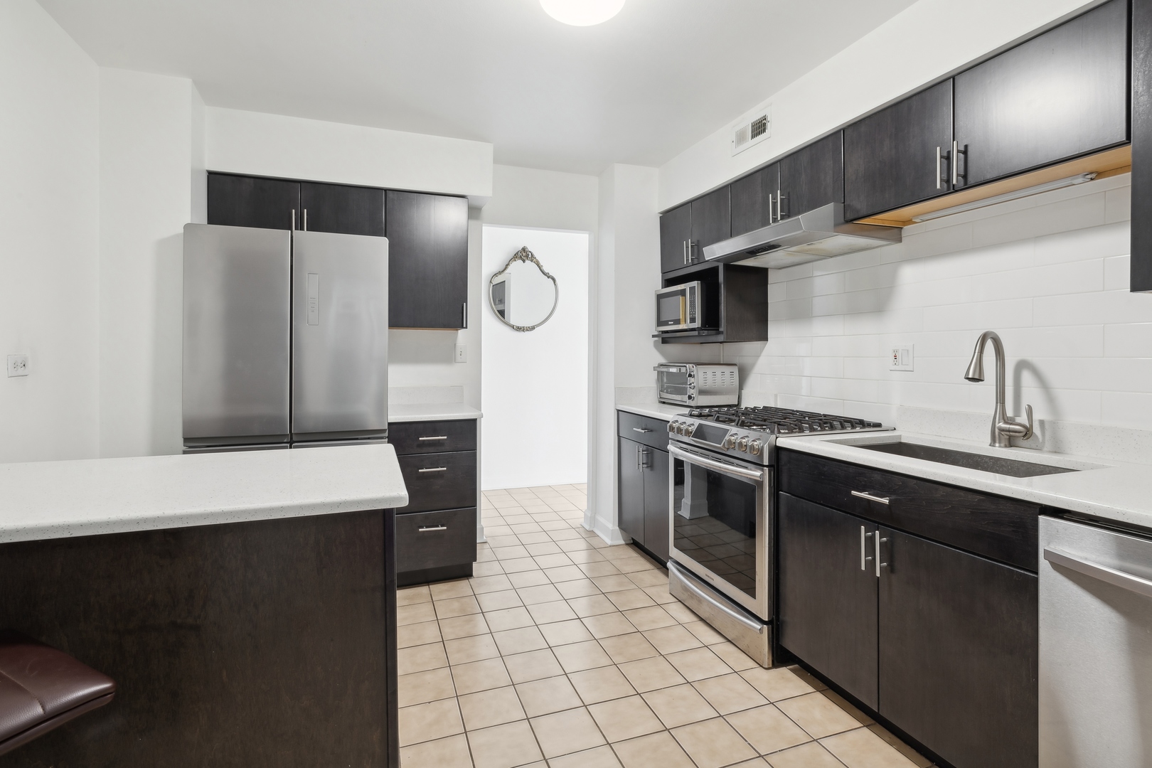 9009 Golf Road, Unit 10F Des Plaines, IL 60016 - Photo 8 of 17 a kitchen with stainless steel appliances a sink and a refrigerator