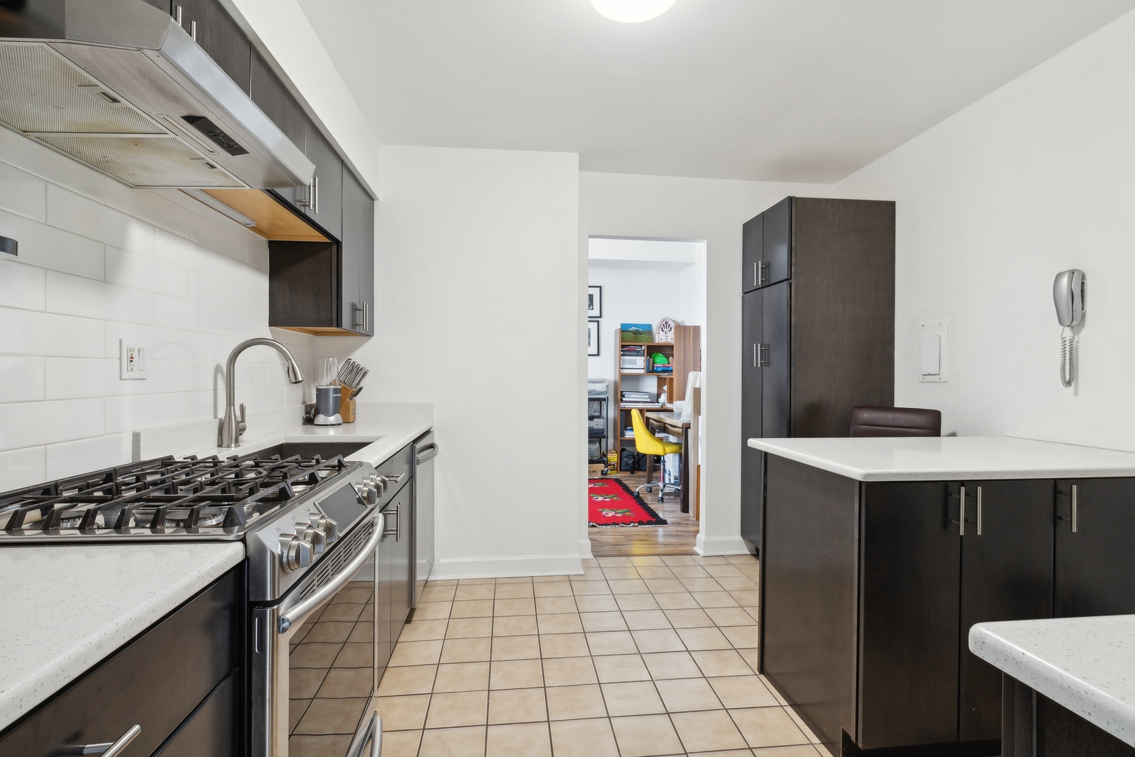 9009 Golf Road, Unit 10F Des Plaines, IL 60016 - Photo 9 of 17 a kitchen with stainless steel appliances granite countertop a sink stove and refrigerator