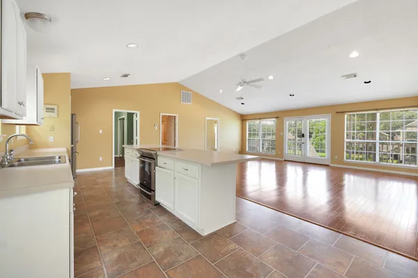 a large white kitchen with a large window