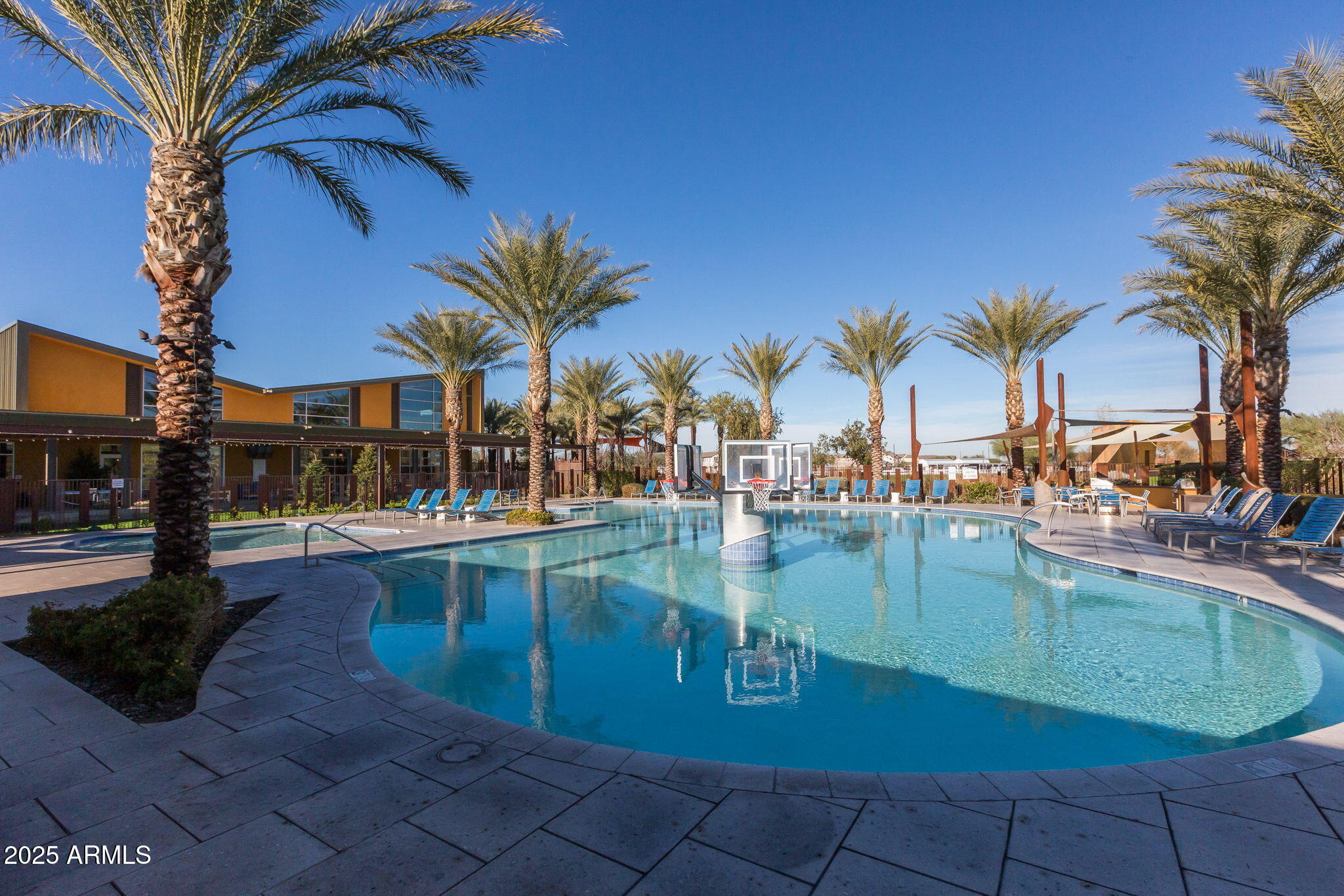 10535 Diffraction Avenue Mesa, AZ 85212 - Photo 112 of 126 a view of a swimming pool with a table and chairs