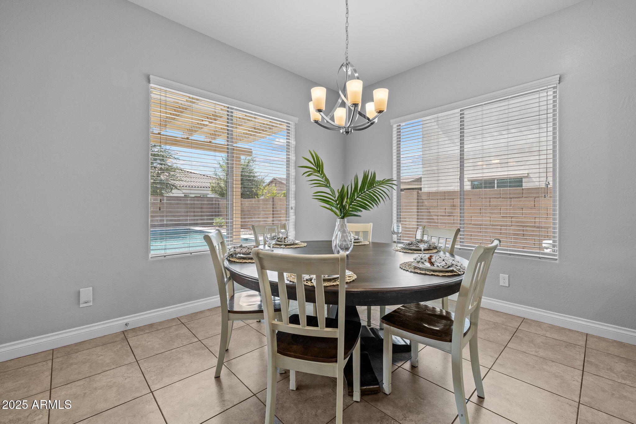 10535 Diffraction Avenue Mesa, AZ 85212 - Photo 29 of 126 a view of a dining room with furniture a chandelier and wooden floor