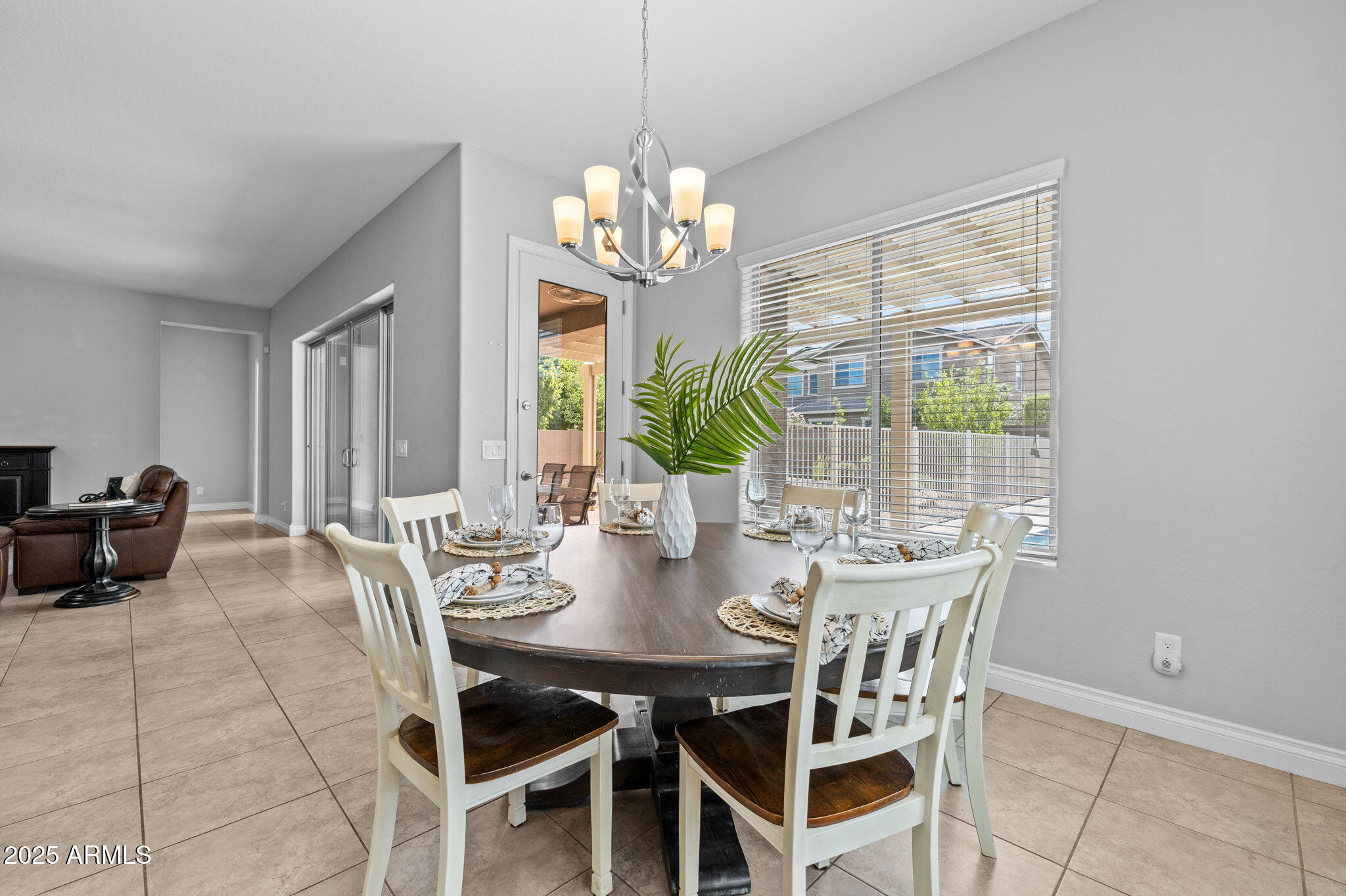 10535 Diffraction Avenue Mesa, AZ 85212 - Photo 30 of 126 a view of a dining room with furniture a chandelier and wooden floor