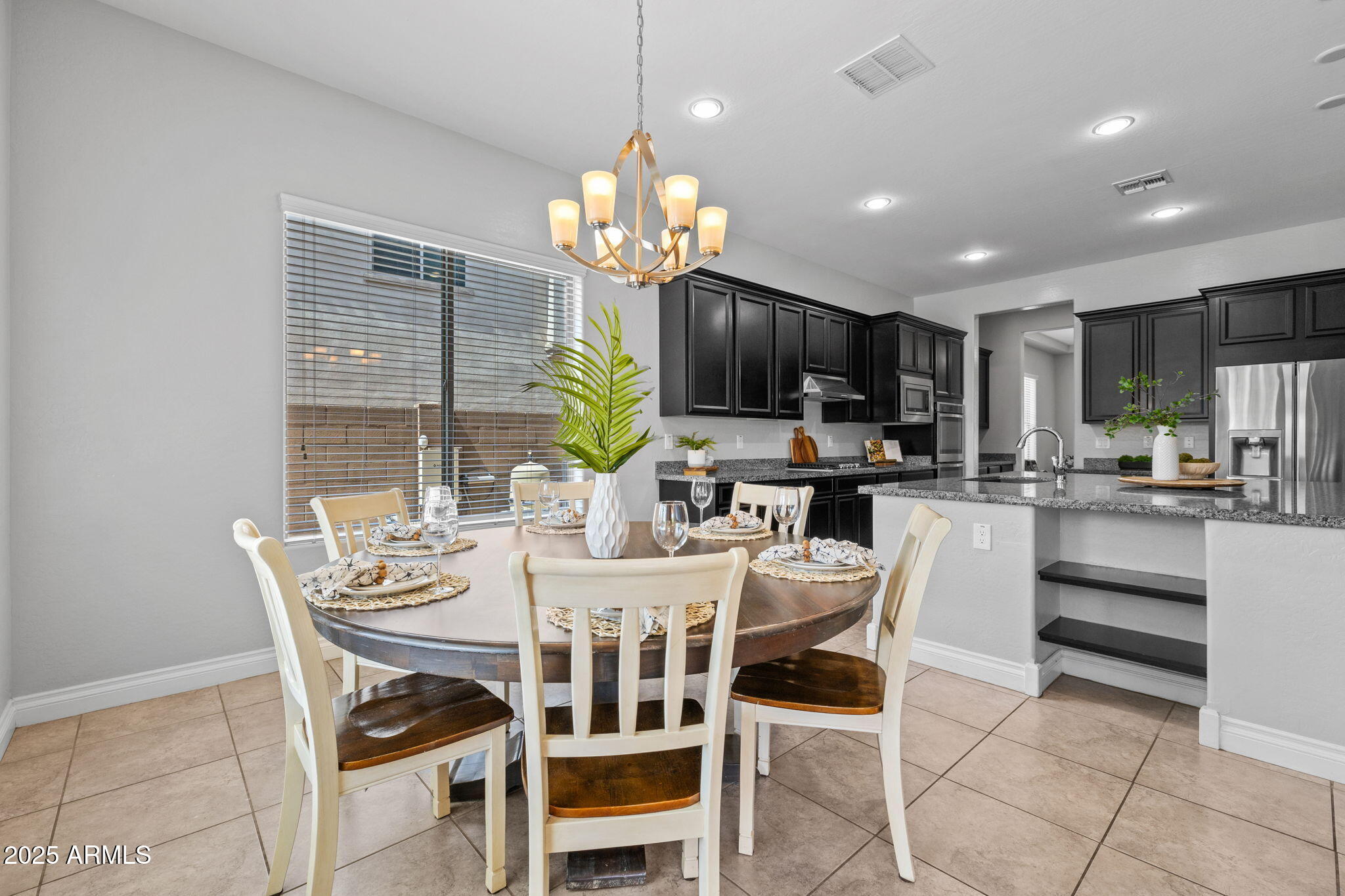 10535 Diffraction Avenue Mesa, AZ 85212 - Photo 32 of 126 a view of a dining room with furniture a chandelier and window