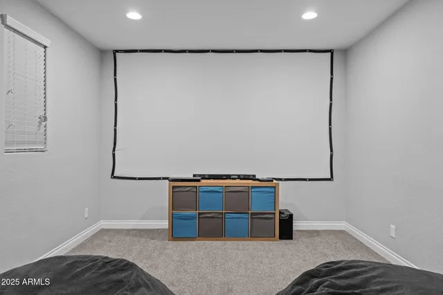 a living room with patio furniture and a floor to ceiling window