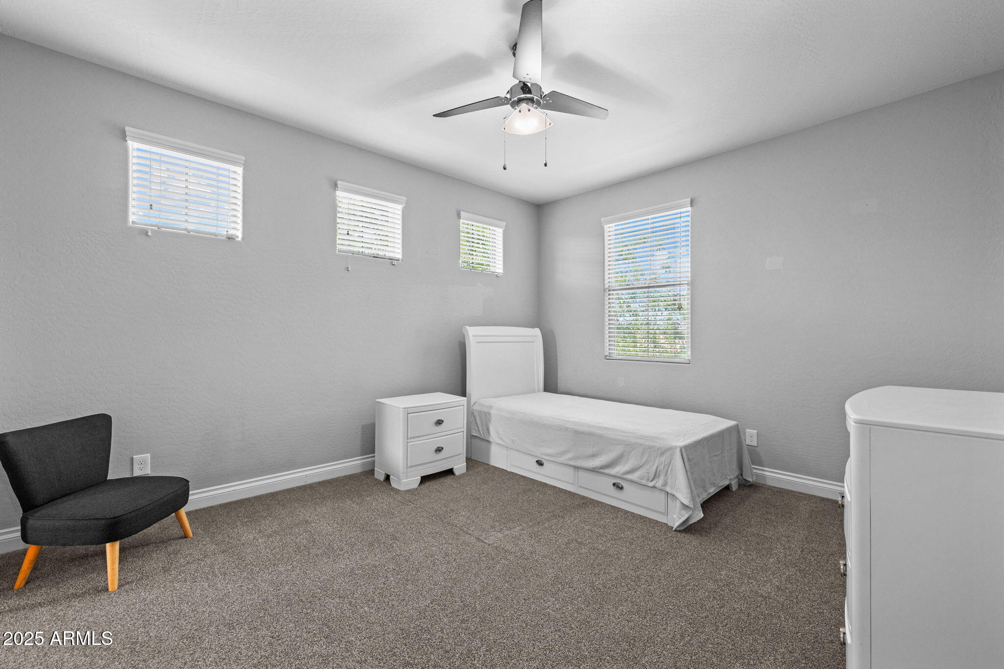10535 Diffraction Avenue Mesa, AZ 85212 - Photo 46 of 126 a spacious bedroom with a bed and a chair