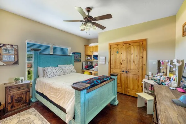 a bedroom with bed and a chandelier