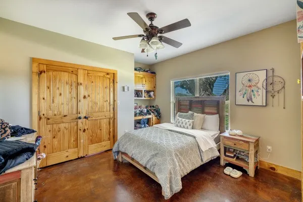 a bedroom with a bed and a chandelier