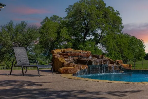 a view of swimming pool with a tree