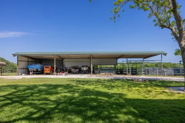 a kitchen with stainless steel appliances granite countertop a sink a granite counter tops and a view of living room