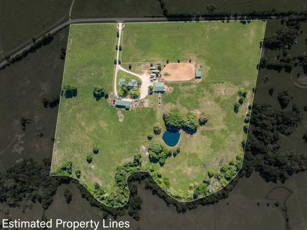 an aerial view of a residential houses with outdoor space