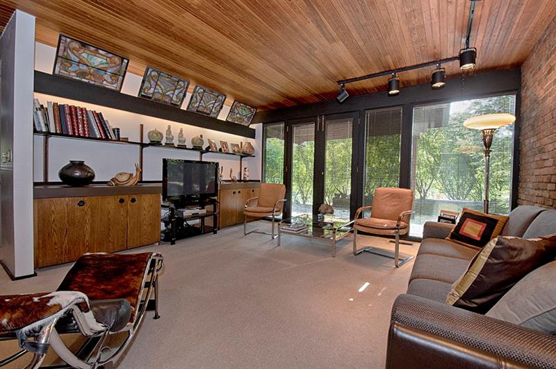 2292 Elmhill Road Pittsburgh, PA 15221 - Photo 22 of 24 lower level family room with custom built-ins and French doors leading to secluded patio