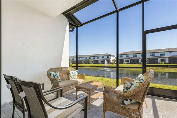 a view of a chairs and table in the balcony