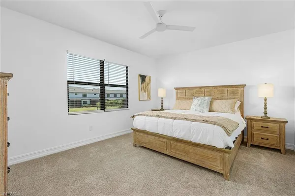 a bedroom with a bed next to a window