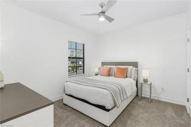 a bedroom with a bed and a book shelf