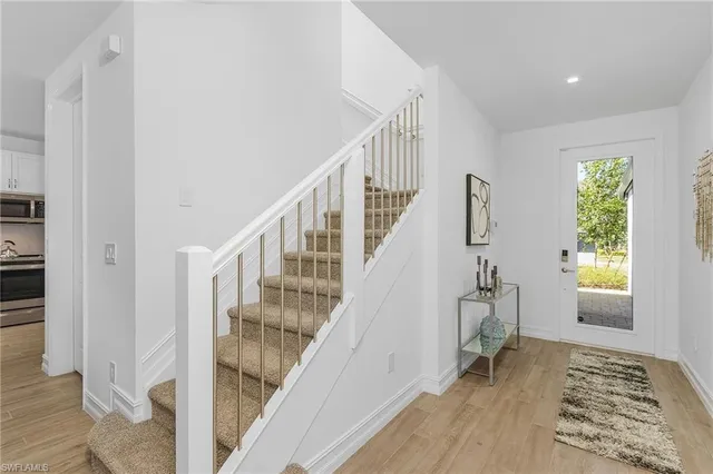 a view of entryway with wooden floor and stairs