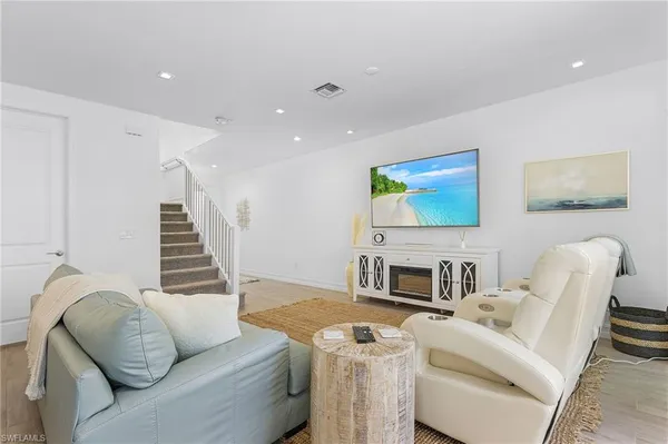 a living room with furniture and a wooden floor