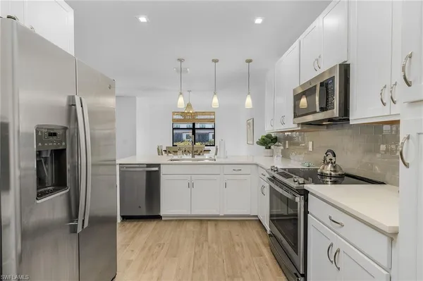 a kitchen with a sink stainless steel appliances and cabinets