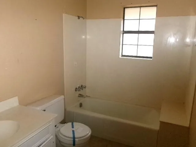 a bathroom with a toilet a sink and a bathtub