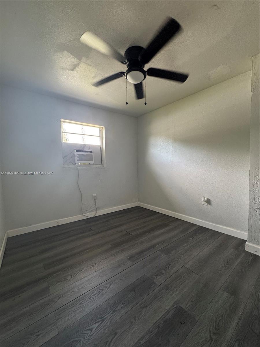 7802 Northwest 8th Avenue, Unit 2 Miami, FL 33150 - Photo 2 of 7 an empty room with wooden floor and windows
