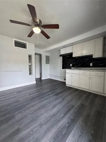 a view of a kitchen with a dishwasher and wooden floor