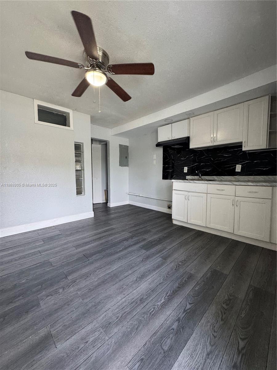 7802 Northwest 8th Avenue, Unit 2 Miami, FL 33150 - Photo 4 of 7 a view of a kitchen with a dishwasher and wooden floor