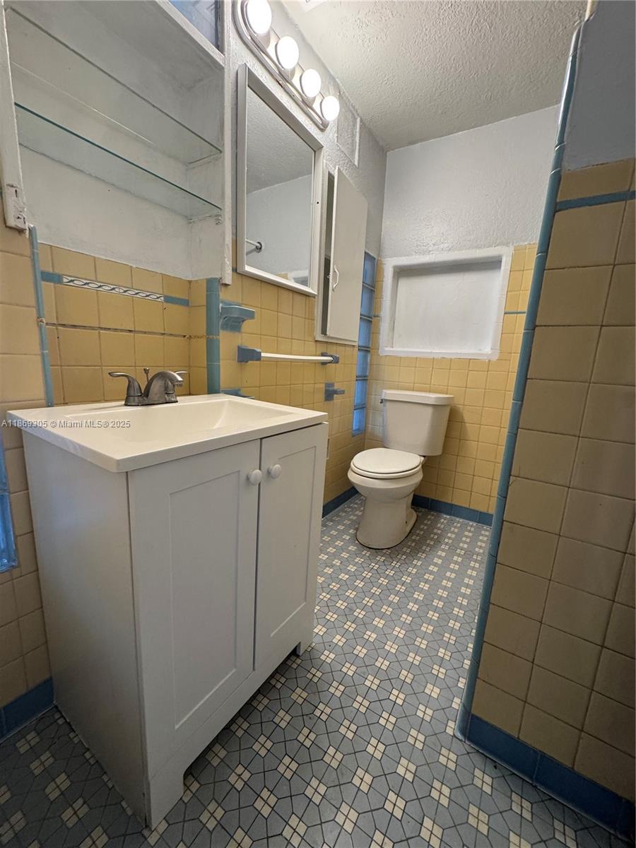 7802 Northwest 8th Avenue, Unit 2 Miami, FL 33150 - Photo 5 of 7 a bathroom with a sink toilet and shower