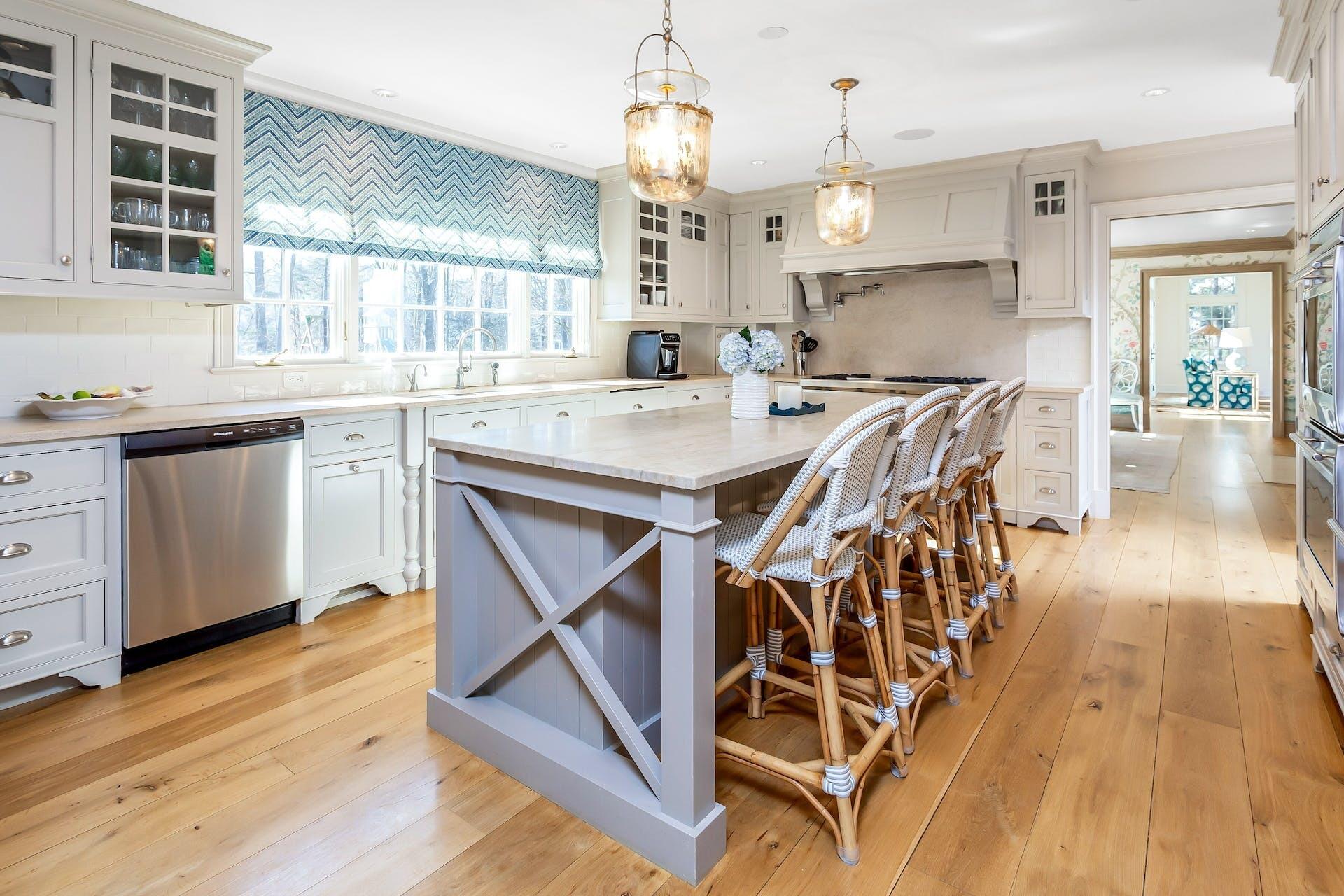 100 Pembroke Road Darien, CT 06820 - Photo 12 of 43 a open kitchen with stainless steel appliances kitchen island granite countertop a stove a sink dishwasher and white cabinets with wooden floor
