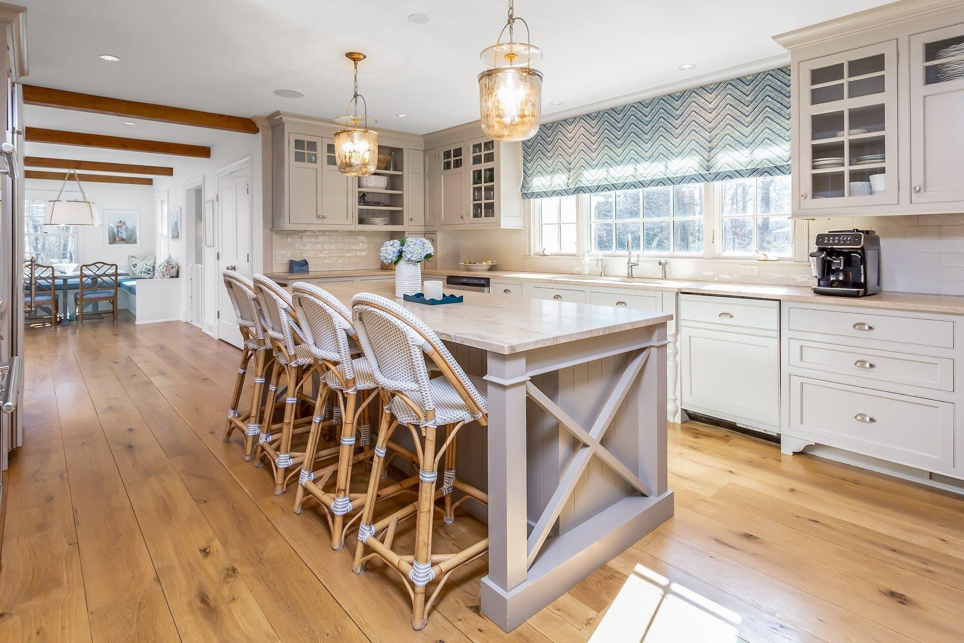 100 Pembroke Road Darien, CT 06820 - Photo 13 of 43 a open kitchen with a table chairs and white cabinets