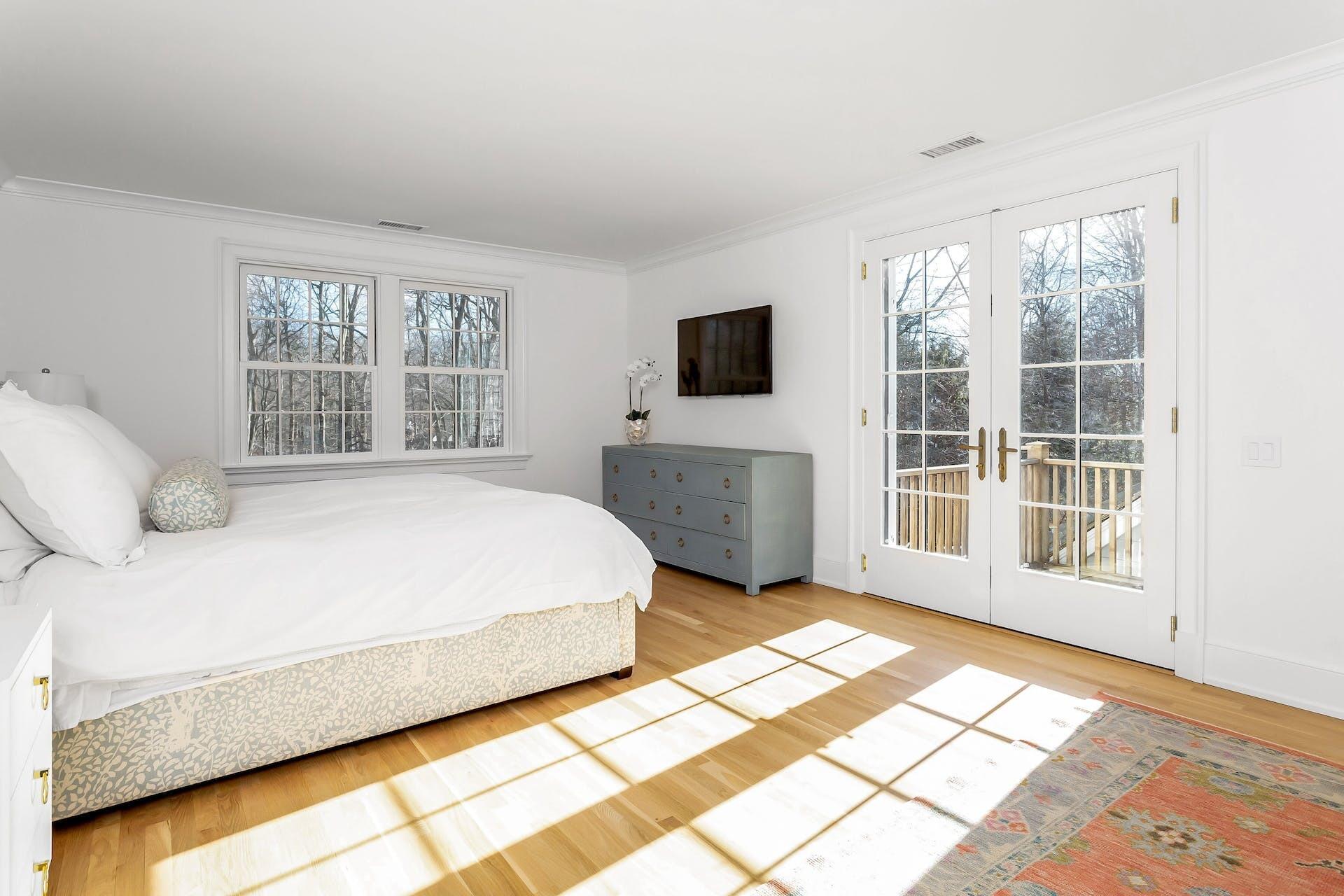 100 Pembroke Road Darien, CT 06820 - Photo 23 of 43 a spacious bedroom with a bed and a television