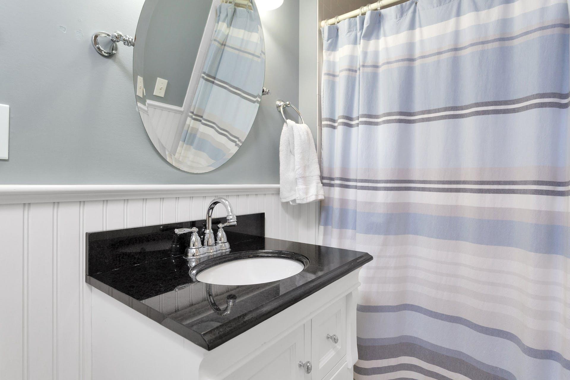 100 Pembroke Road Darien, CT 06820 - Photo 35 of 43 a bathroom with a sink and a mirror