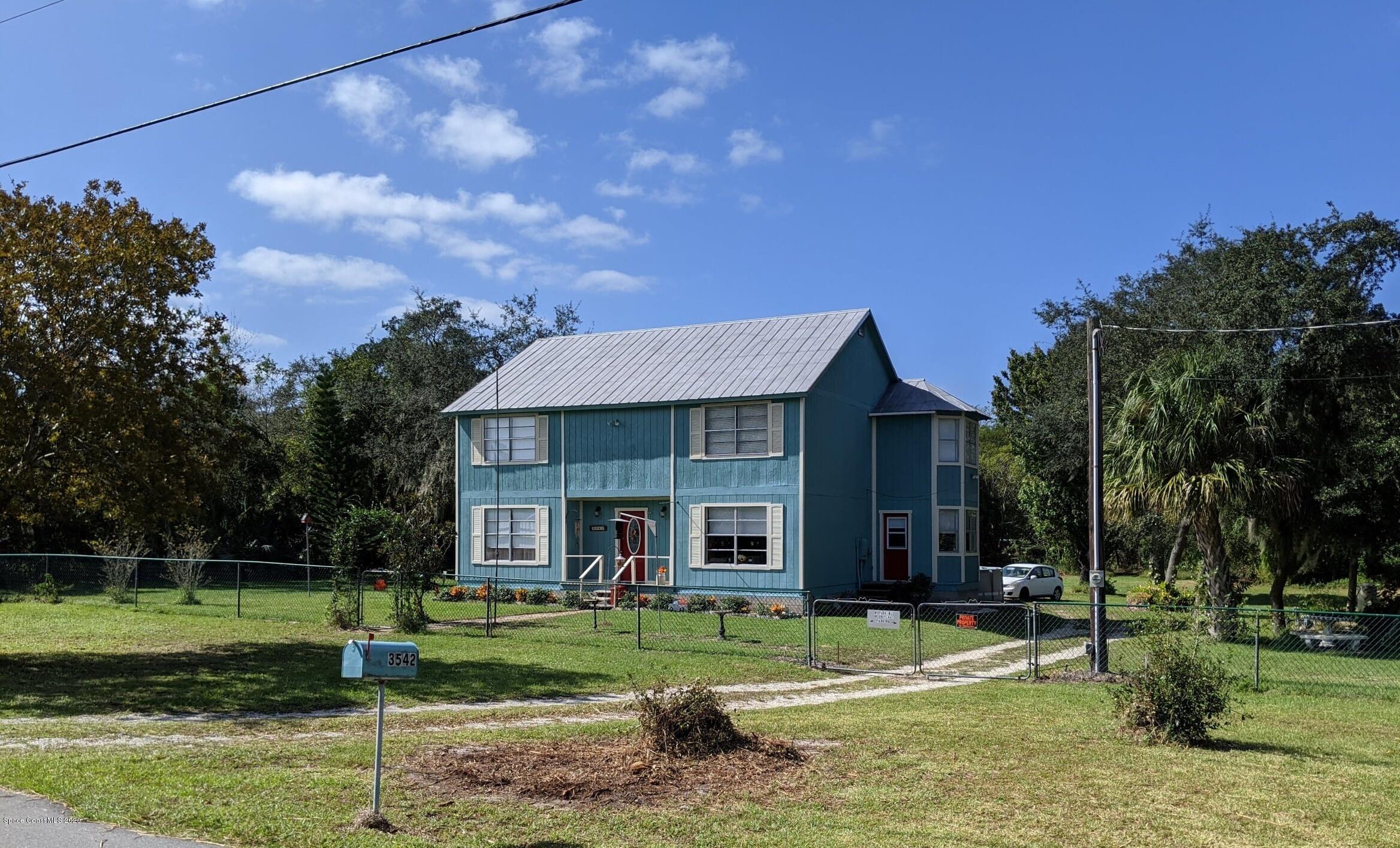 3542 Brevard Road Mims, FL 32754 - Photo 3 of 66 a view of a house with a yard