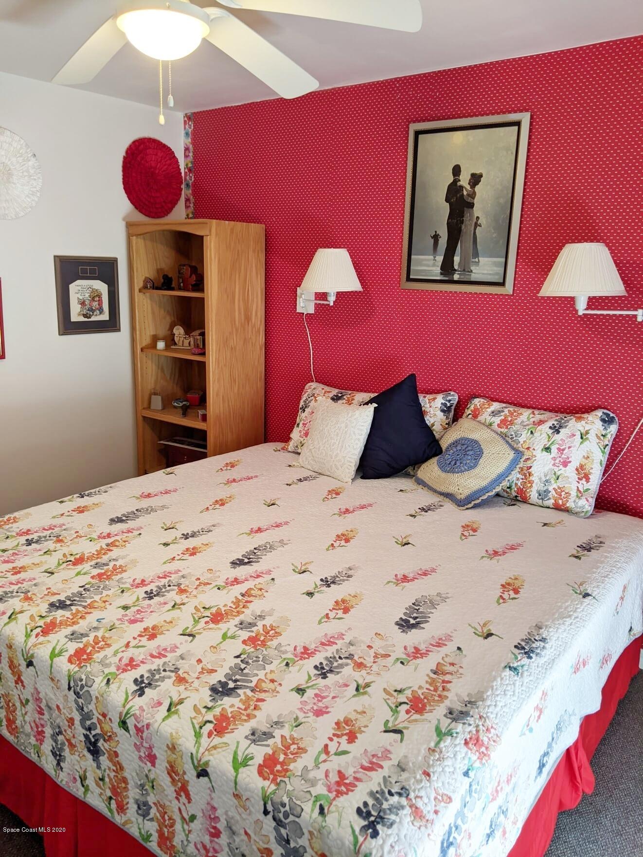 3542 Brevard Road Mims, FL 32754 - Photo 40 of 66 a bedroom with a bed and a lamp