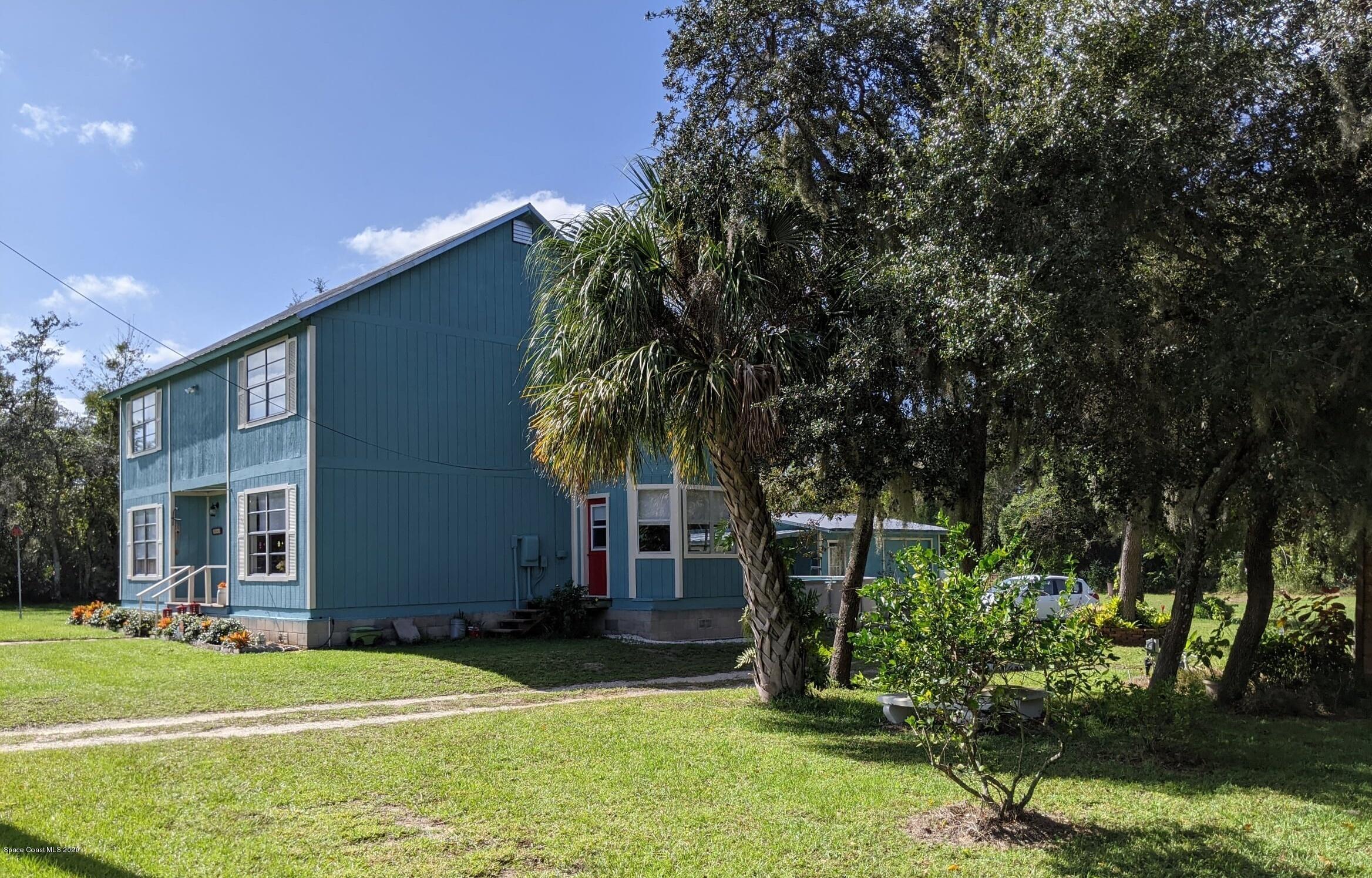 3542 Brevard Road Mims, FL 32754 - Photo 8 of 66 a front view of a house with a yard