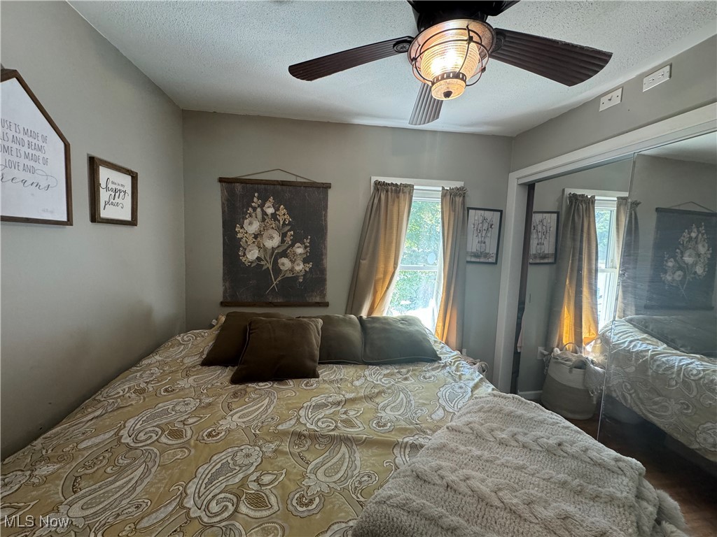 1480 Jerrys Run Road Belleville, WV 26133 - Photo 30 of 48 Bedroom with a textured ceiling, ceiling fan, and a closet