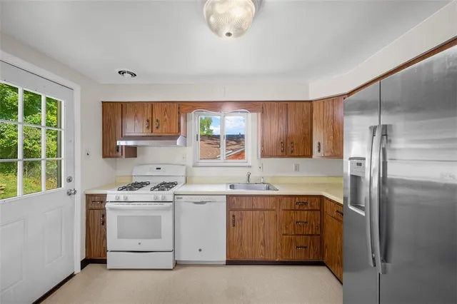 a kitchen with a sink stove and refrigerator
