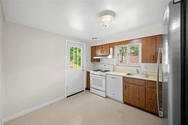 a kitchen with a sink stove and cabinets